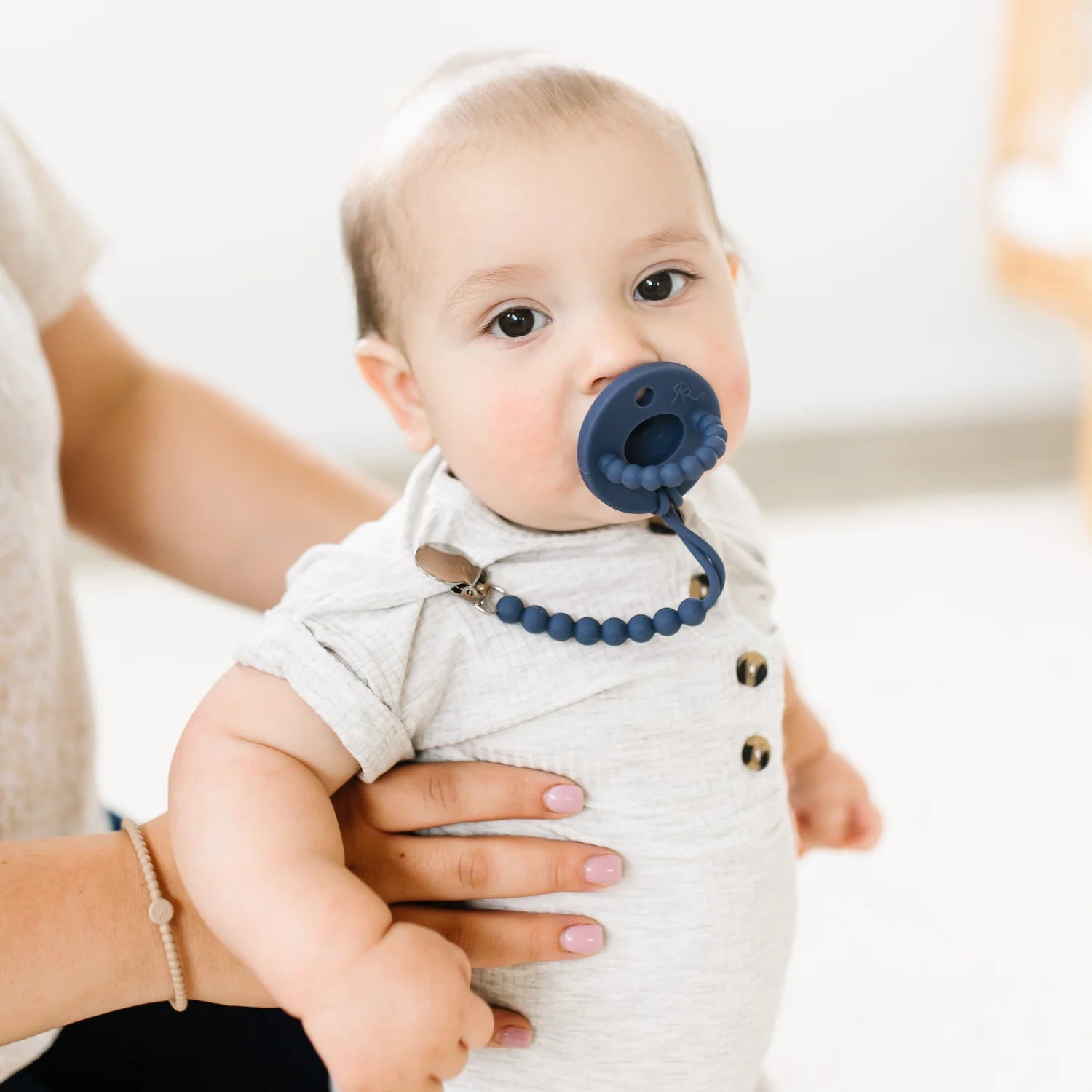 Baby wearing pacifier and clip