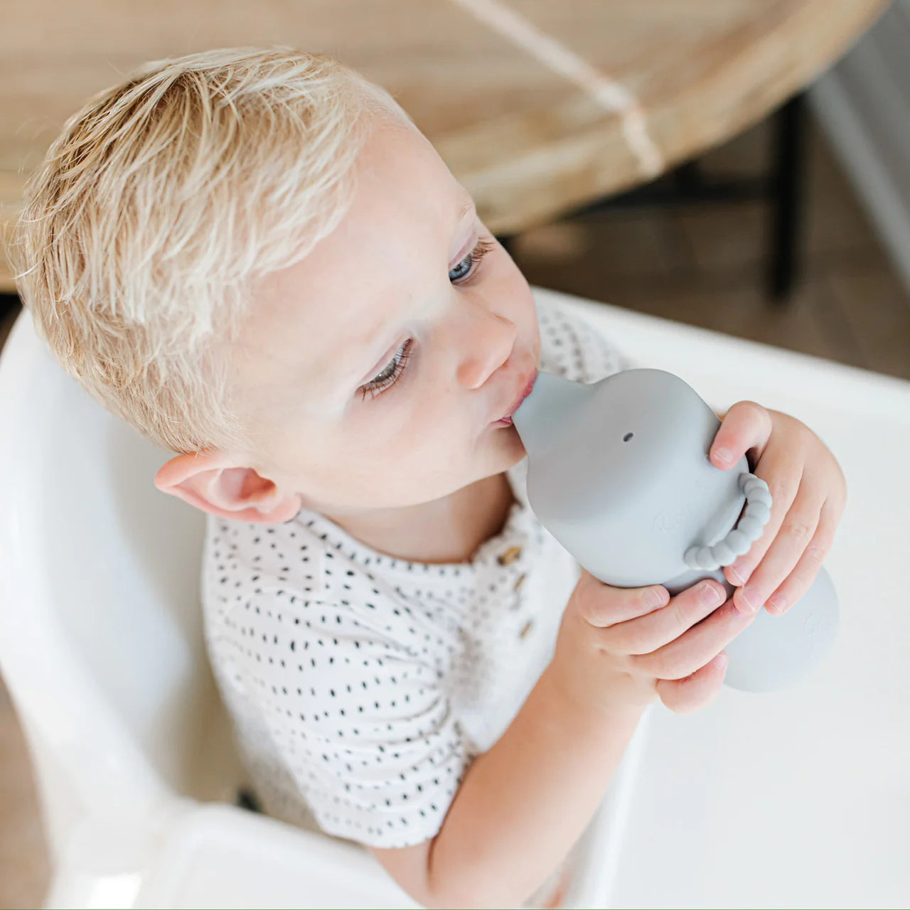 Toddler sipping out of a Cutie Sippy Cup