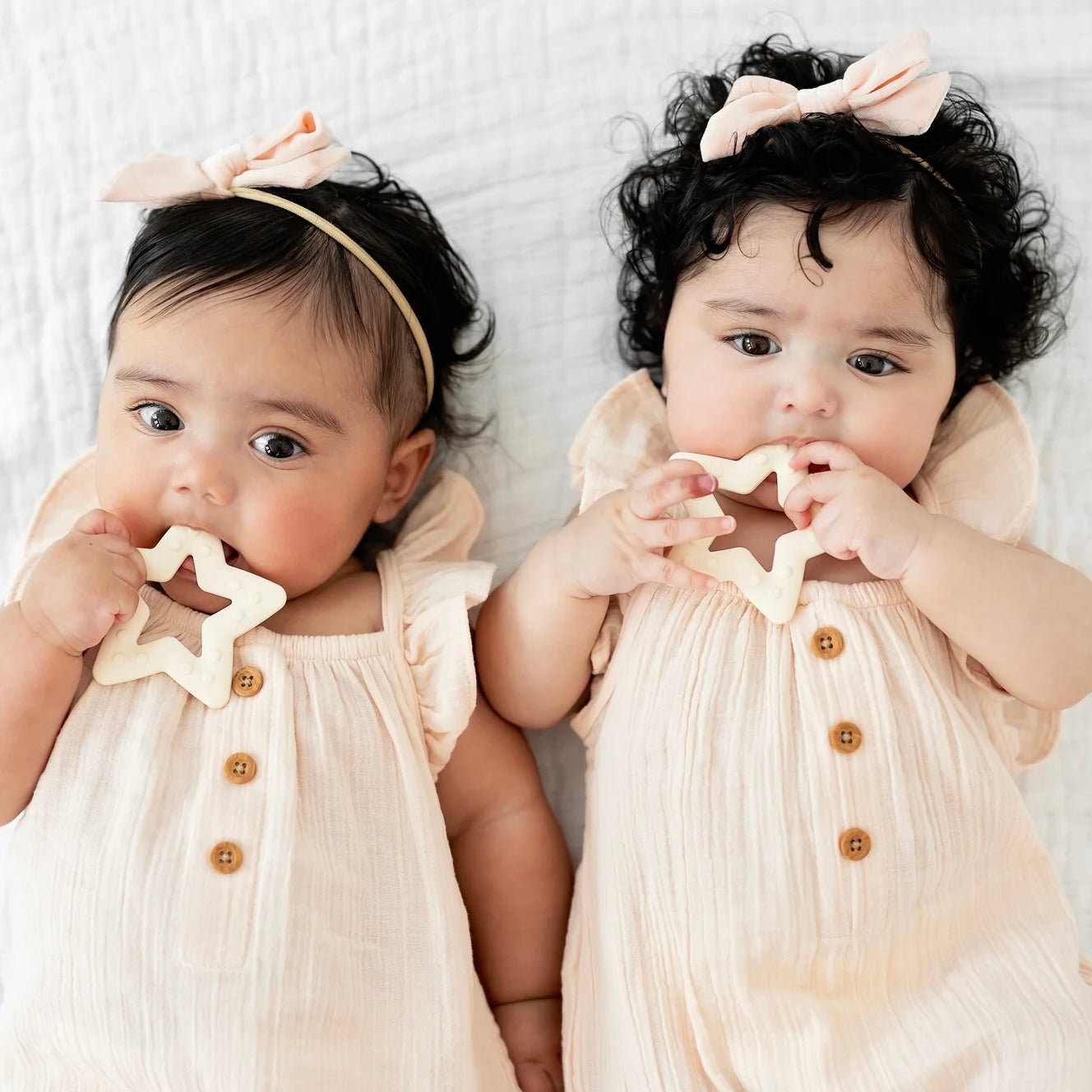 Twin girls playing with Star teethers