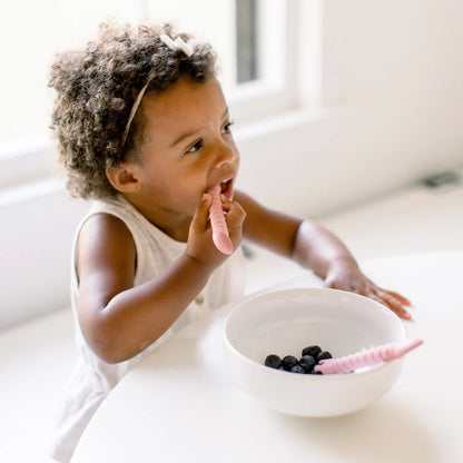 Kid eating blueberries with Tensils