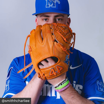 Person wearing a blue baseball uniform and orange glove with &