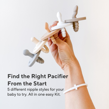 Hand holding pacifiers