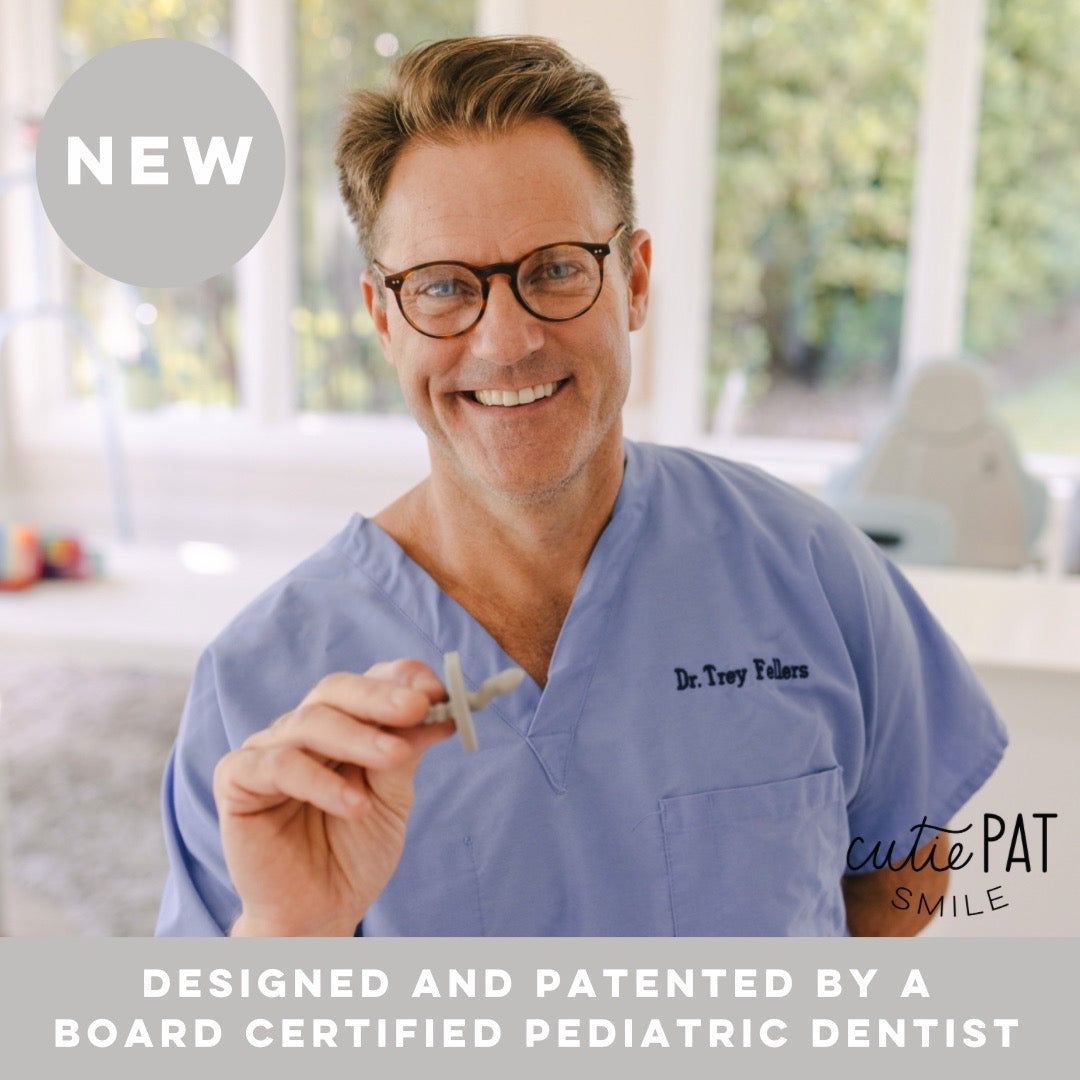 Dr. Trey holding a Cutie PAT Smile. Designed and patented by a Board Certified Pediatric Dentist.