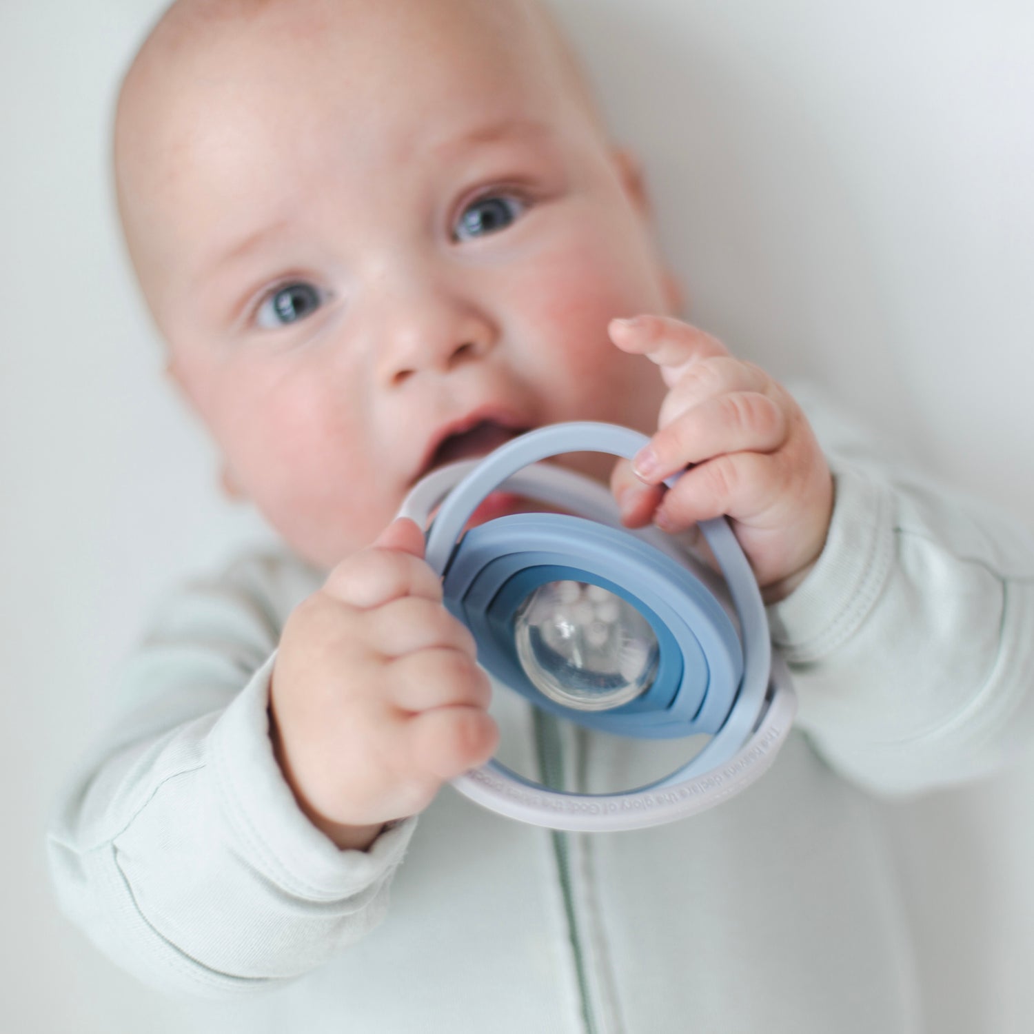 Baby playing with universe rattle toy