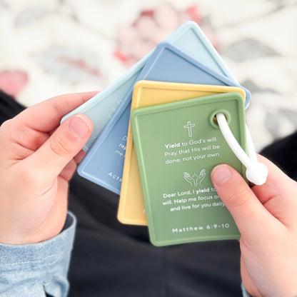 Boy holding prayer cards