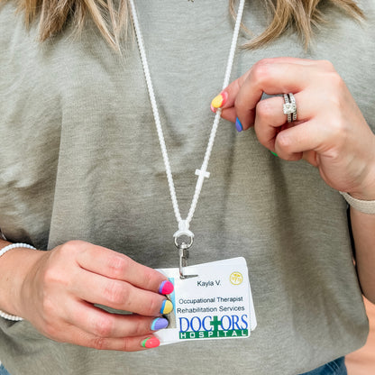 Person wearing a lanyard with an occupational therapist badge from Doctors Hospital.