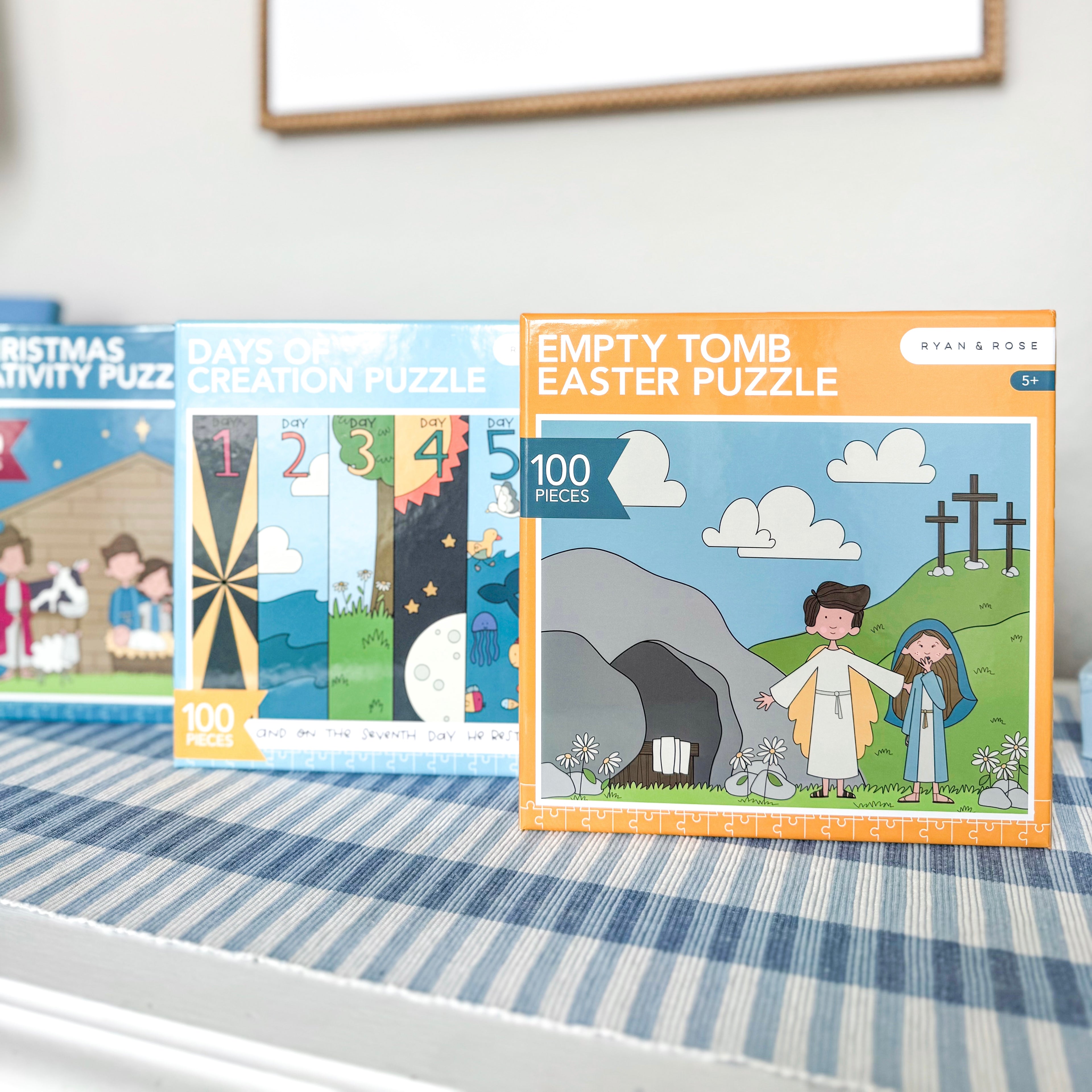 Three educational puzzles on a table with a white wall background