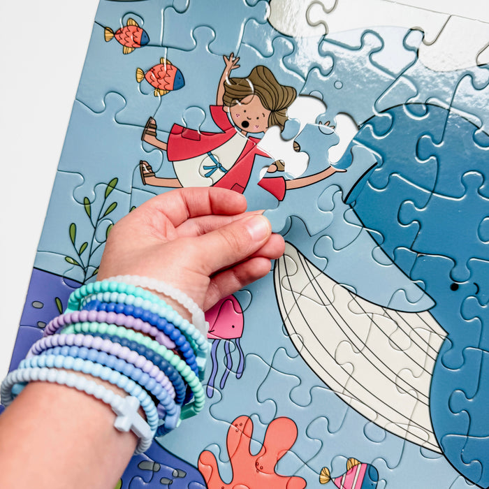 Hand completing a puzzle with an underwater scene design