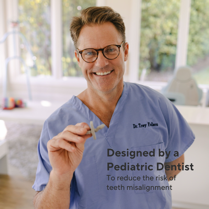 A smiling man in blue medical scrubs holds a small dental device while standing in a bright dental office. Text on the image reads, &