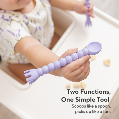 Child holding a purple spoon and fork-like tool, with text &
