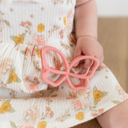 Baby playing with butterfly teether