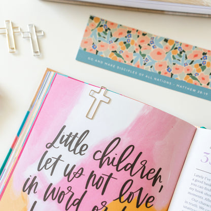 cross paper clip on a bible