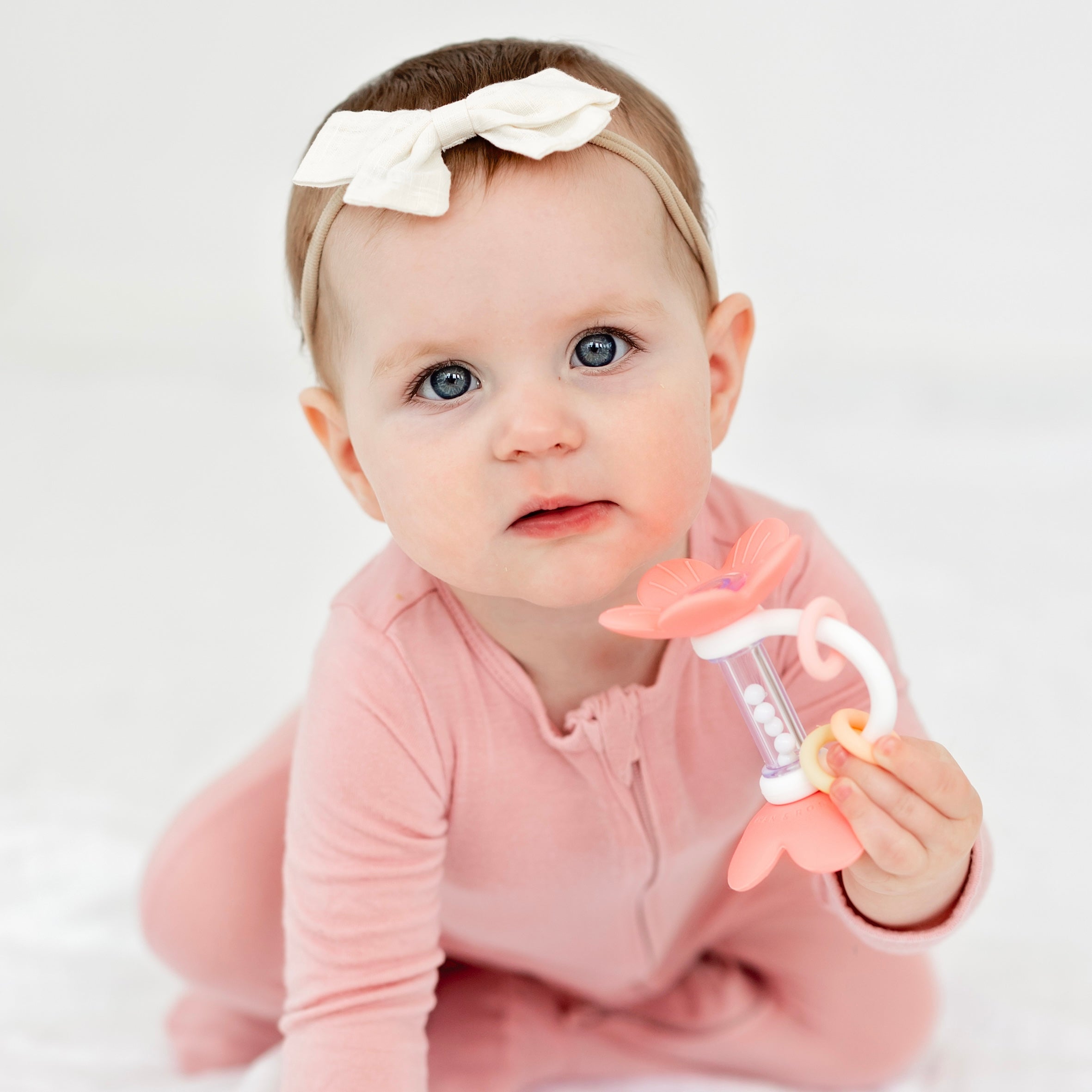 Baby crawling with flower rattle toy