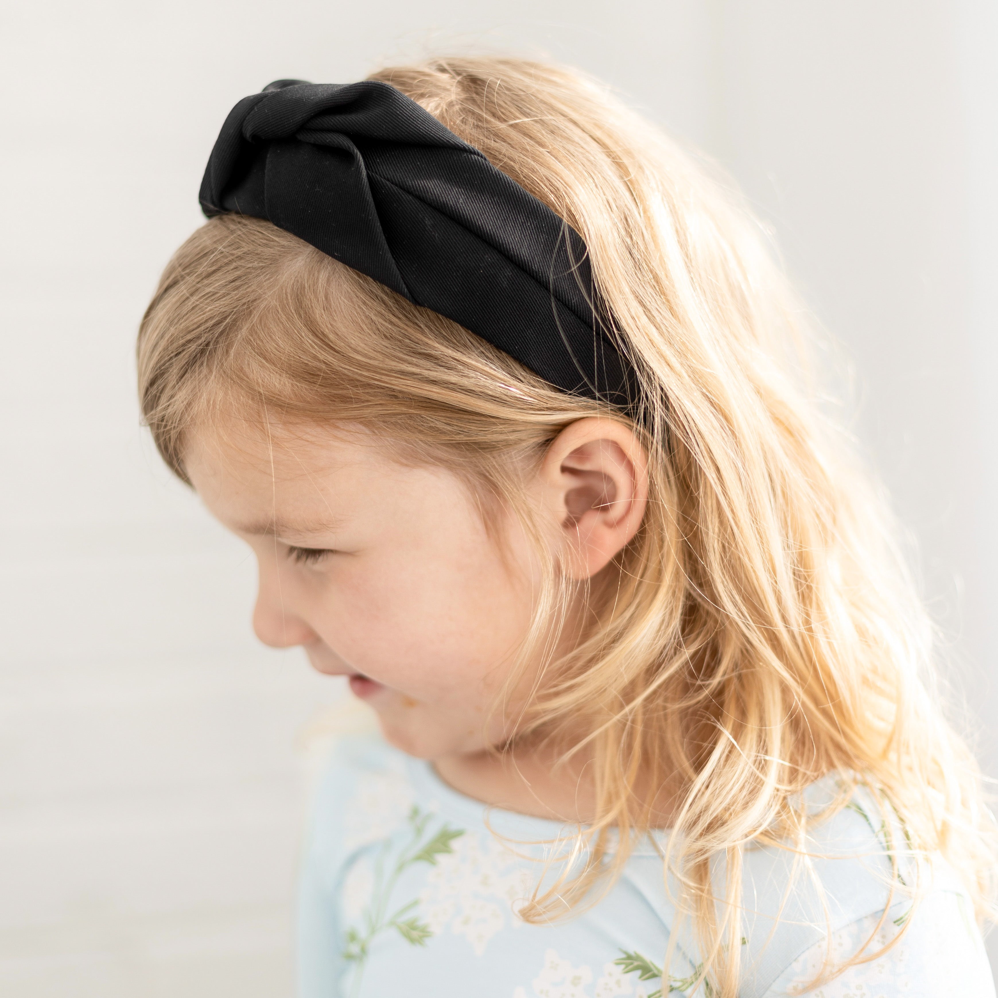 Girl wearing the Black Cutie Headband.