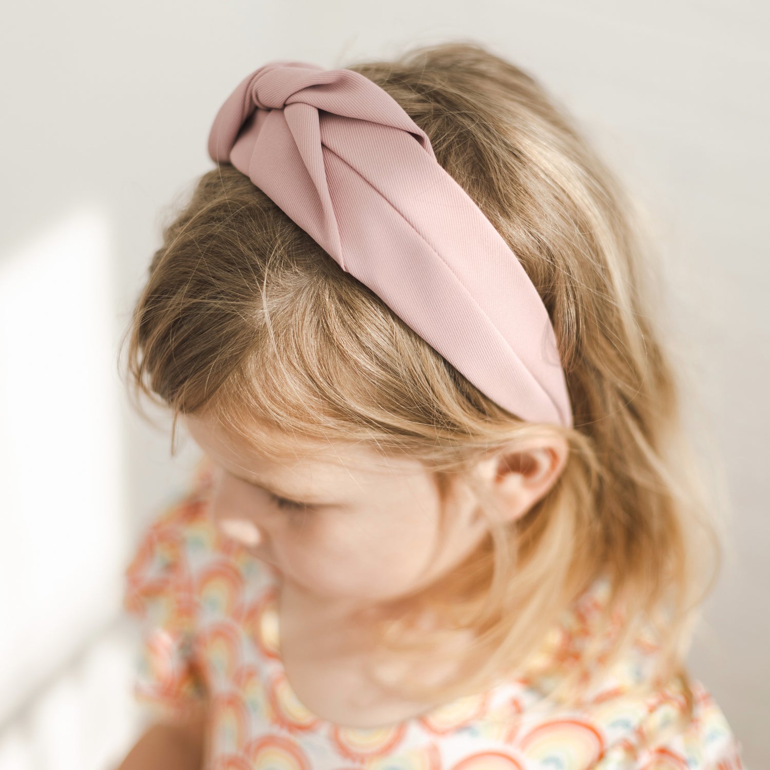 Girl wearing the Mauve Cutie Headband.