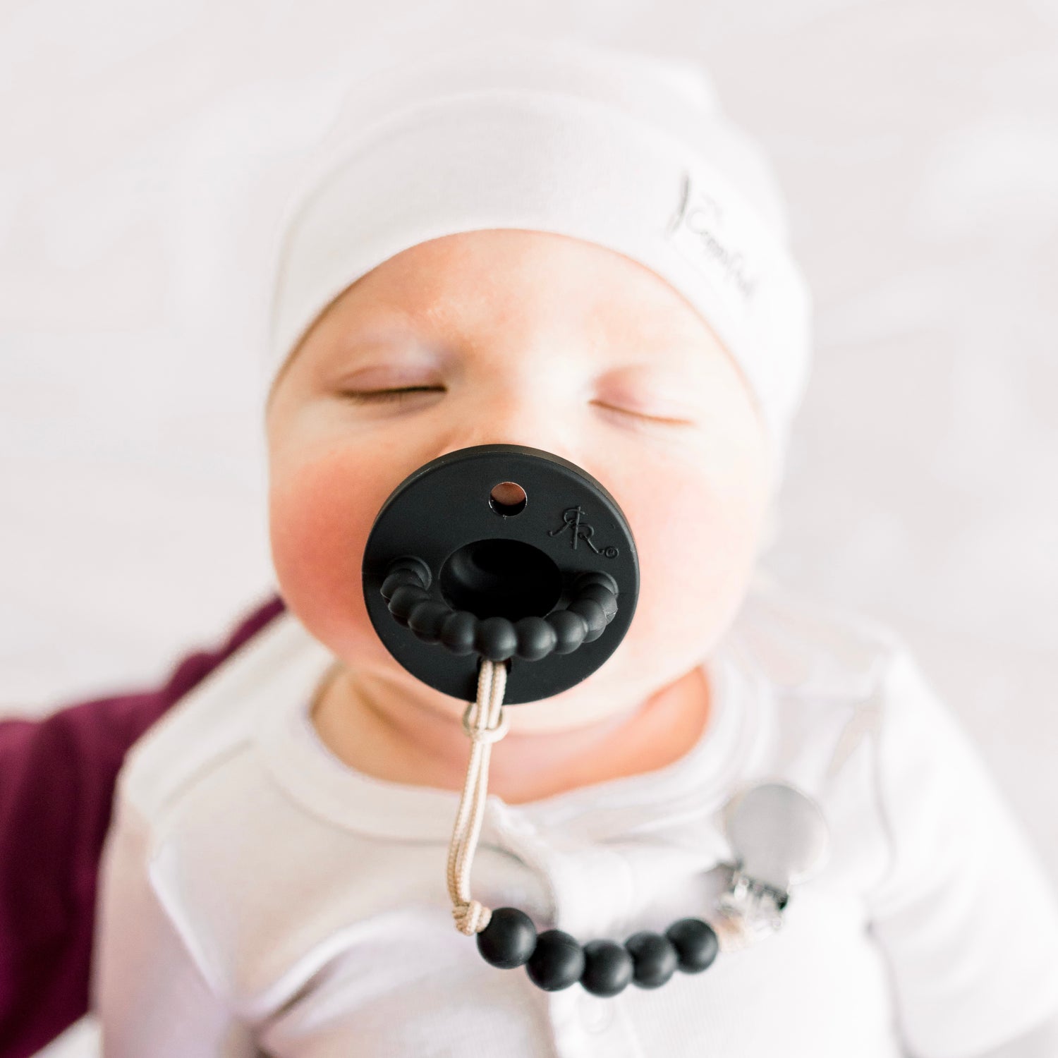 Baby boy wearing a Black Cutie PAT and Quinn Cutie Clip.