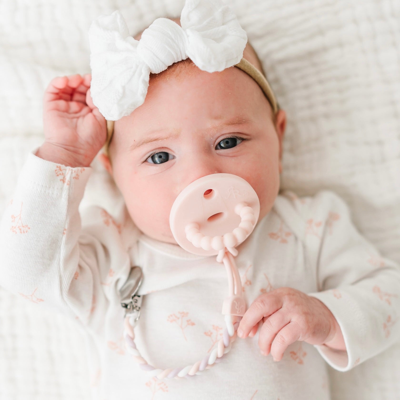 Baby girl wearing a Pink Cutie PAT and Braiden Cutie Clip.