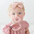 Baby girl wearing a Ballerina Cutie PAT and Hart Cutie Clip.