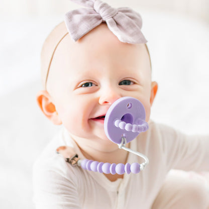 Baby girl using a Lavender Cutie PAT and Olivia Cutie Clip.