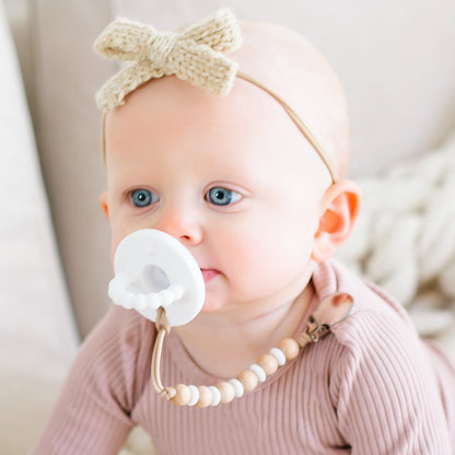 Baby girl wearing a White Cutie PAT and Ella Cutie Clip.