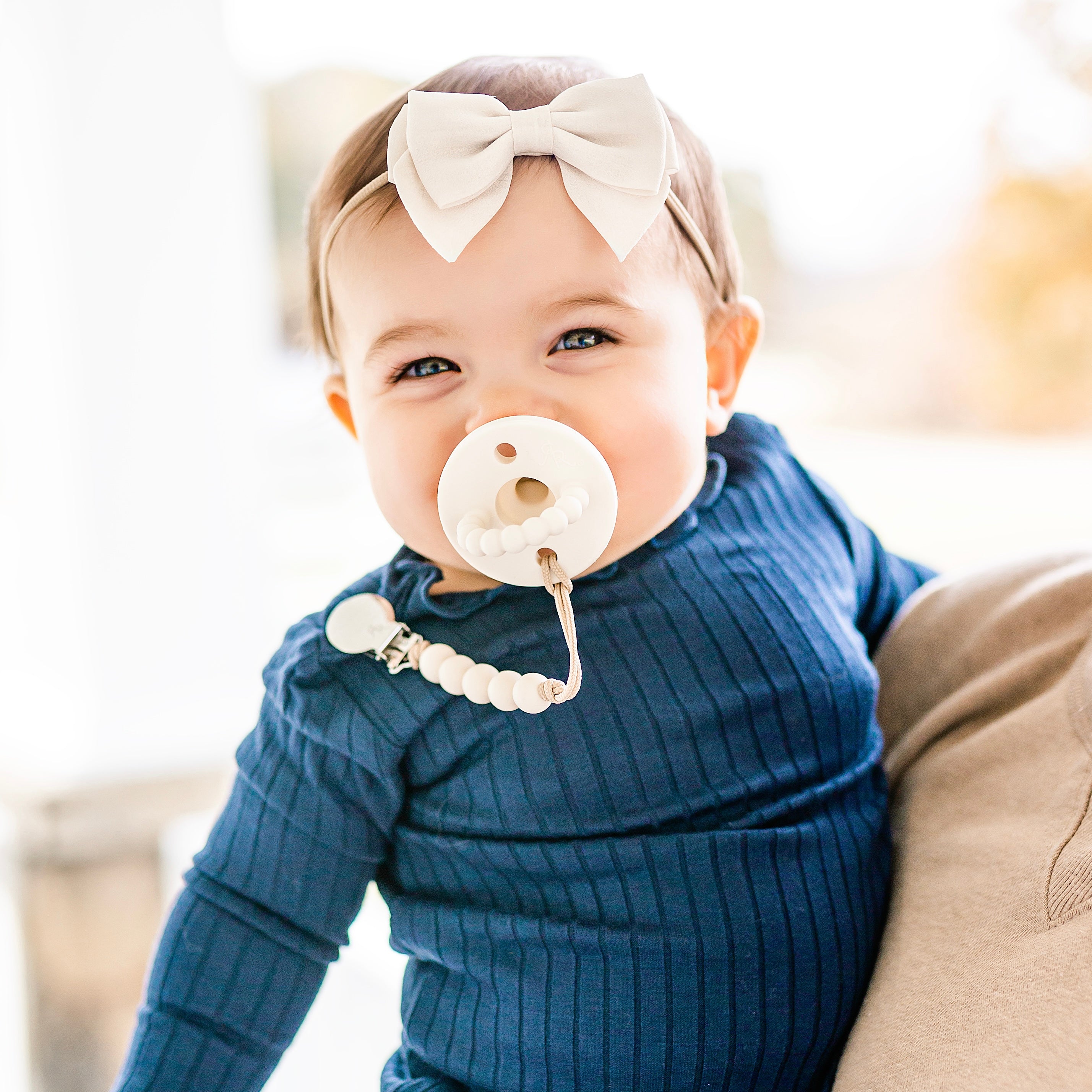 Baby sucking on a pacifier 