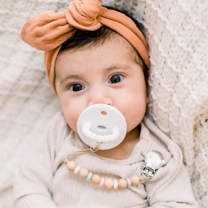 Baby girl wearing a White Cutie PAT and Ella Cutie Clip.