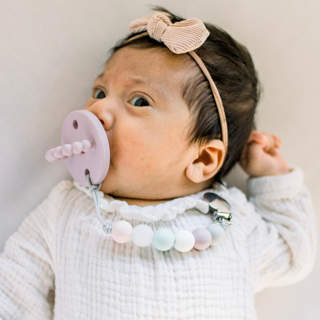 Baby girl wearing a Mauve Cutie PAT and Willard Cutie Clip.