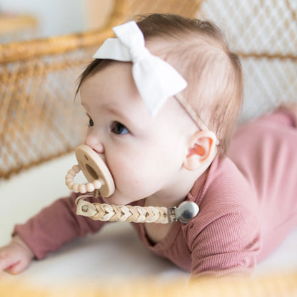 Baby girl wearing a Tan Cutie PAT and Sequoia Cutie Clip.