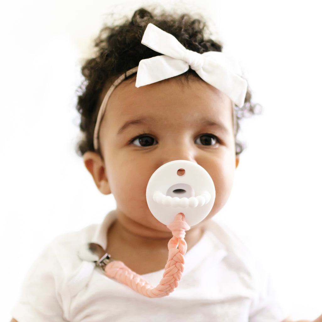 Baby girl wearing a White Cutie PAT and Finn Cutie Clip.