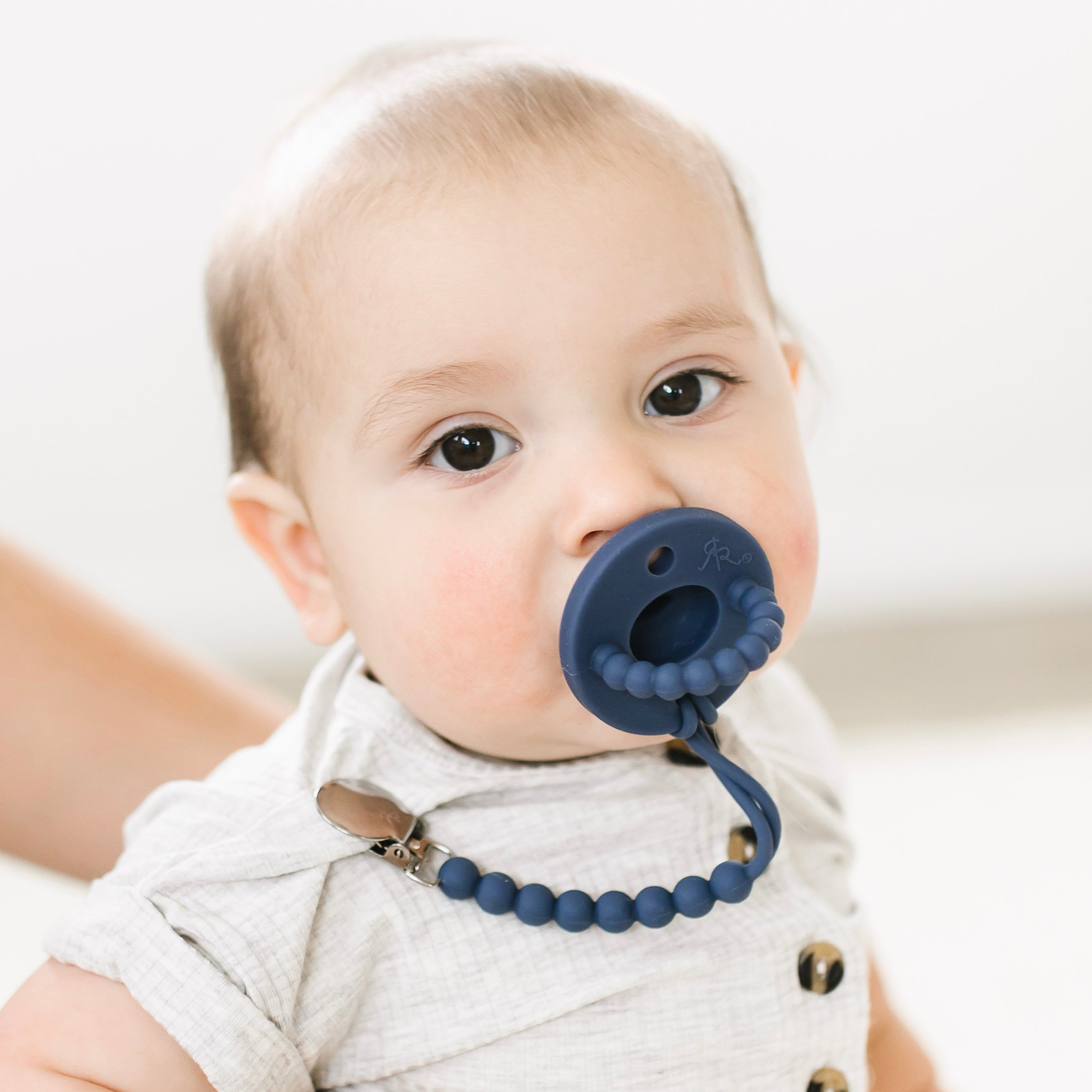 Baby boy wearing a Captain Cutie PAT and Judy Cutie Clip.