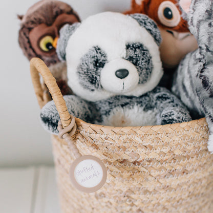 Basket of stuffed animals with a Cutie Tag attached.