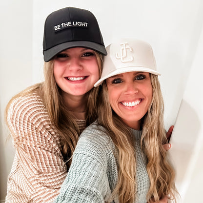 Women wearing Jesus Christ and Be The Light Hats