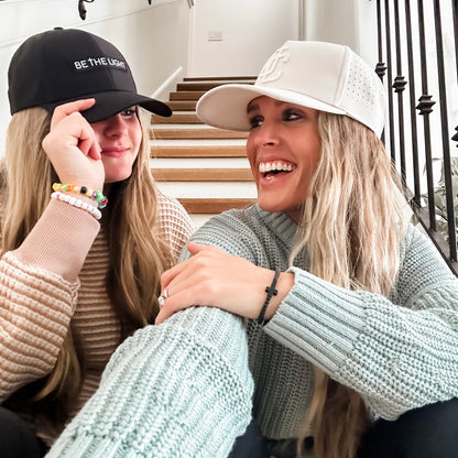 Women wearing Jesus Christ and Be The Light Hats