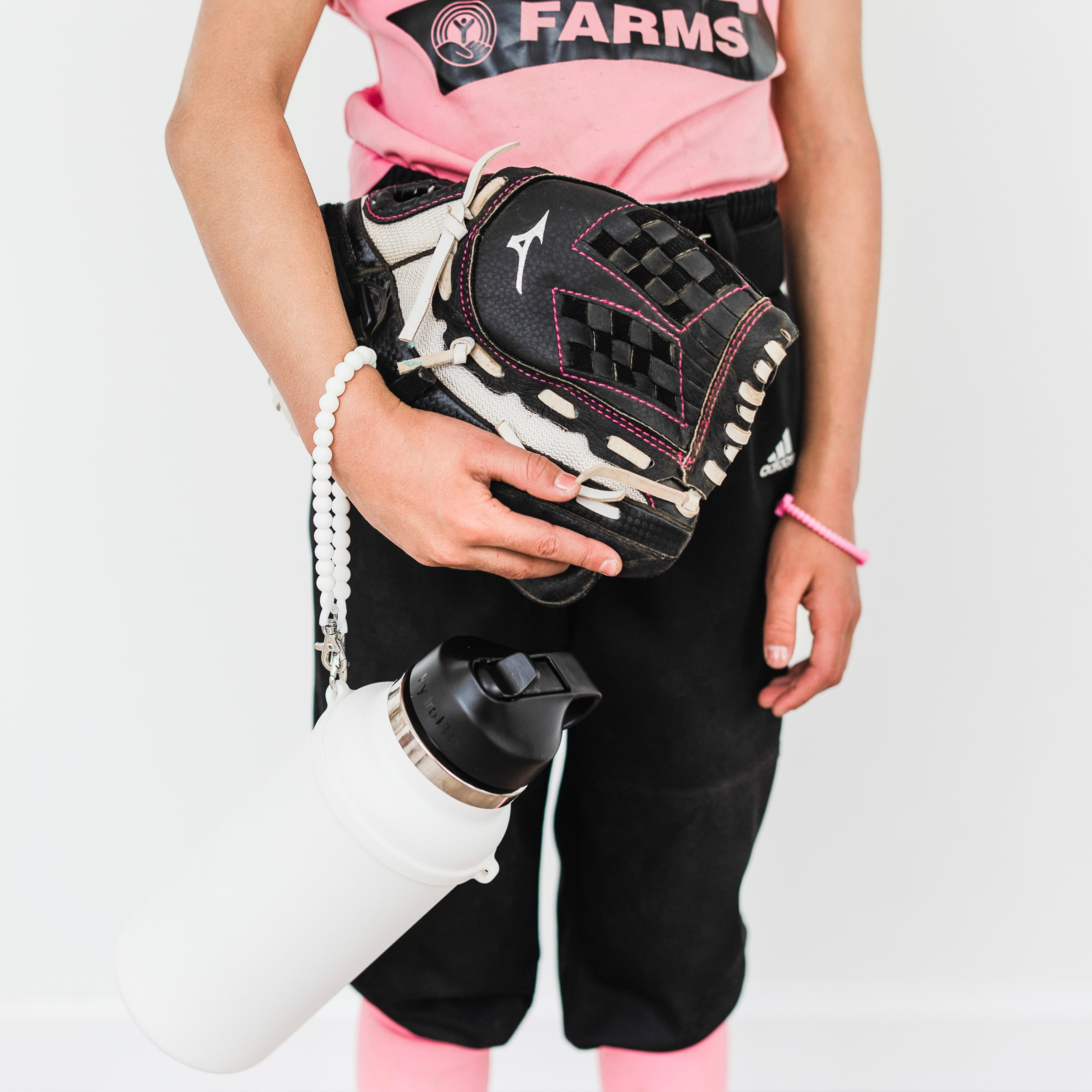Softball player with a White Cutie Handle attached to a water bottle.