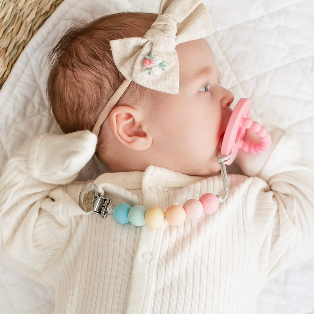 Baby girl wearing a Taffy Cutie PAT and Willard Cutie Clip.