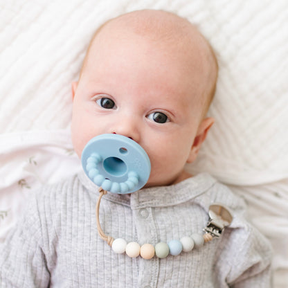 Baby boy using a Blue Cutie PAT and Georgia Cutie Clip.