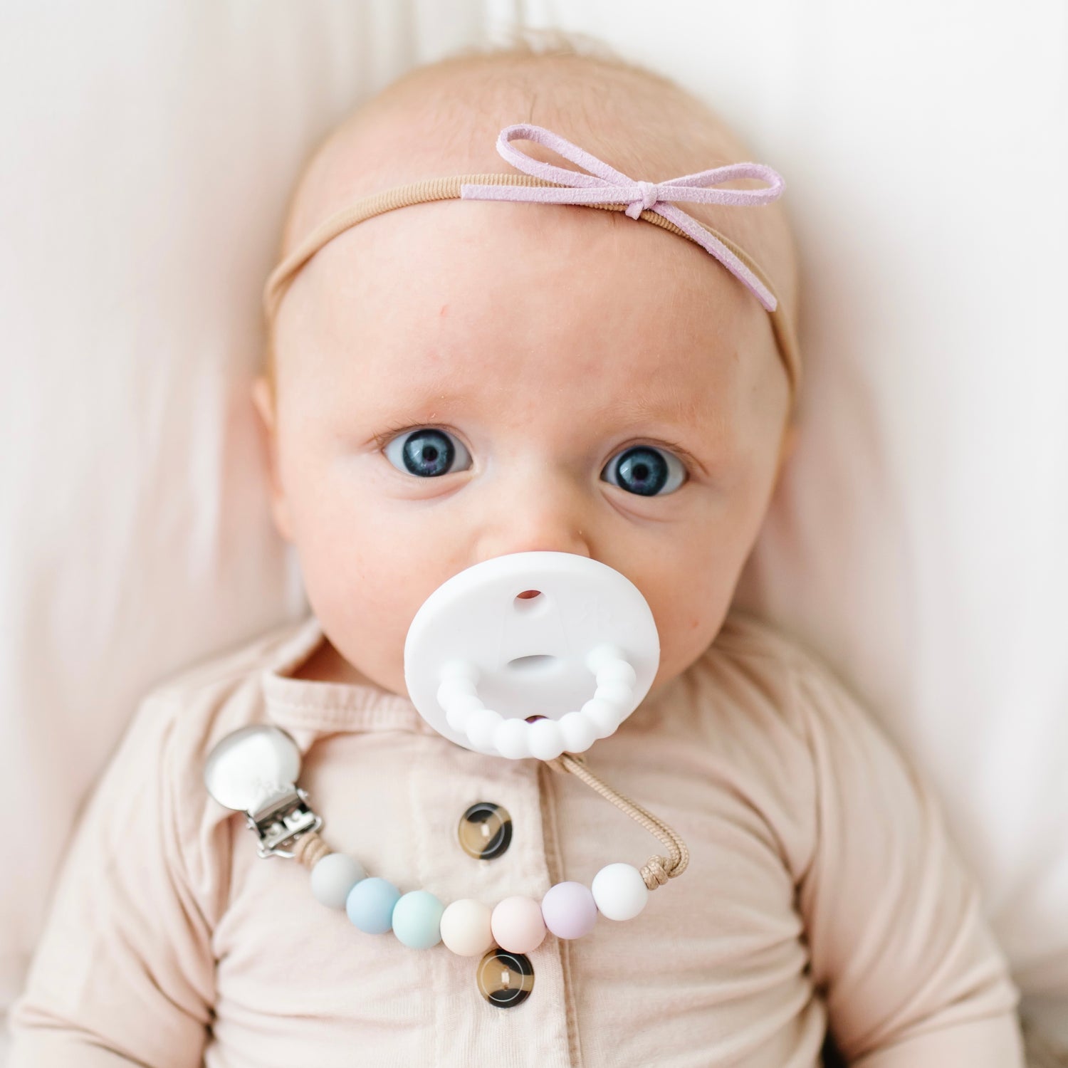 Baby girl using a White Cutie PAT and Georgia Cutie Clip.