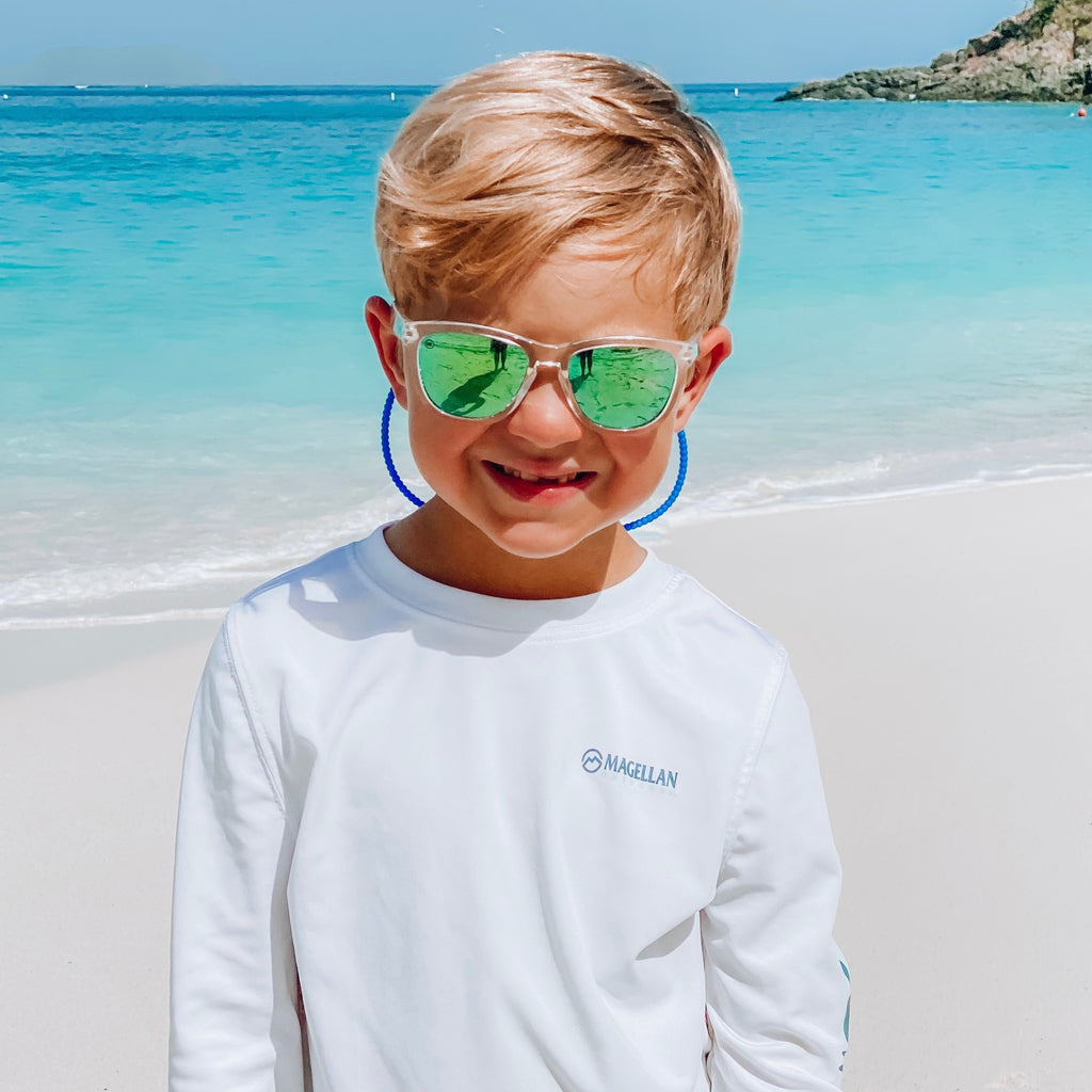Boy at the beach wearing the Memphis Cutie Straps attached to his sunglasses.